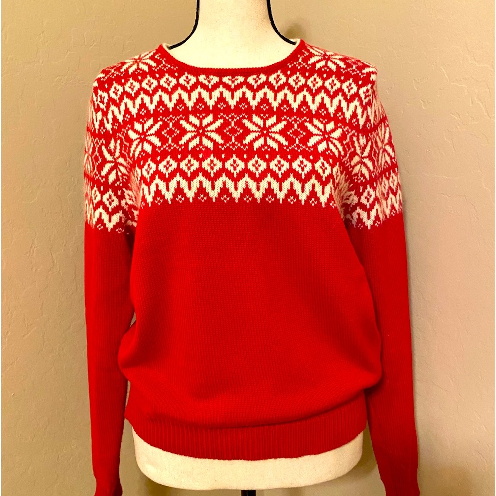 Red sweater, white snowflake on top.